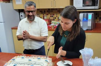 Dr. Chiappinelli cutting a cake to celebrate her tenure